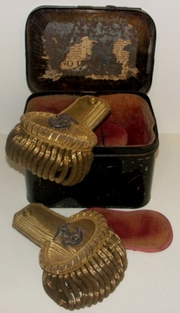 A pair of 19th century officer’s epaulets from the Royal British Navy. Made by Gieve Matthews and Seagrove Ltd. In original tin box marked Hobson & Sons Military Outfitters, London. 