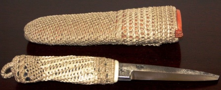 Knife with handforged steel-blade carrying the initials J.A. Handle and leather sheath rope-coated