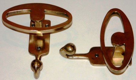 A pair of early 20th century clothes hangers made of solid brass. 