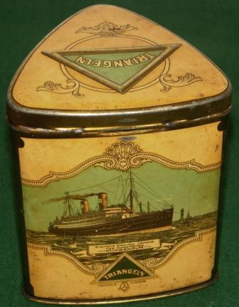 Early 20th century triangular tin-can, decorated with three different motifs depicting the Swedish American Liner M/S Kungsholm, New York Harbour and Gothenburg Harbour.