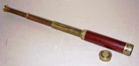 Early 20th century hand-held refracting telescope, maker unknown. Three brass draws and mahogany bound tube. 