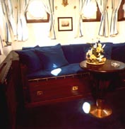 Part of a suite onboard a hotel ship, furnished with restored 20th century ship's bunk bed and table.