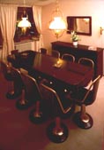 Part of a bank's boardroom furnished with restored 20th century ship's table, swivel chairs , sideboard, mirror and newly made brass lamps.