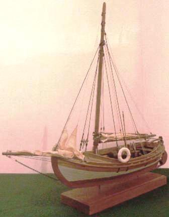 Gaff-sail rigged open boat with compression-ignition engine.