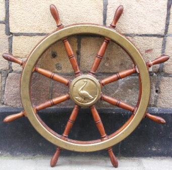 Late 19th century eight-spoked mahogany ships wheel with double brass bands and a central brass hub decorated with a casted swan