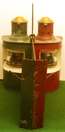 An unusual pair of early 20th century navigation lamps made in a single unit housing both the port and starboard oil-burning lamps in one and the same case. Red and green painted case with detachable light-separating unit. Marked with three crowns St 18772. 