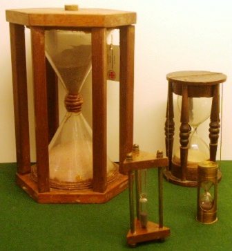 19th and 20th century sand glasses mounted in wooden or brass frame.