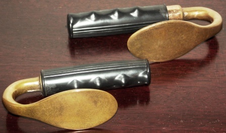 A pair of 20th century cuff spoons. Brass, rubber-dressed handles. Made by Siebe Gorman.
