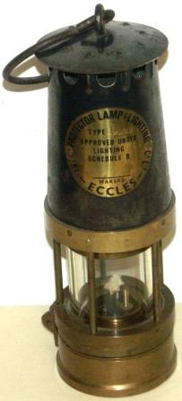 20th century kerosene protector/inspection lamp made of brass and metal. Protector Lamp & Lighting Co Ltd, makers Eccles. Type 1 J.C.M. Approved under lighting schedule B. 65/ N. 13