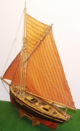 A very detailed 20th century wooden model depicting a 19th century North Sea Fishing Cutter, fully equipped with fishing gear. 