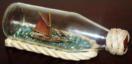 20th century ship model housed in bottle depicting a British cutter, built in Brixham in early 20th century. Signed GF (Göran Fors). 