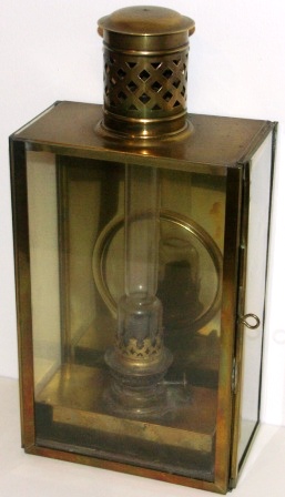 19th century kerosene bulkhead lamp in brass. With detachable burner/container. 
