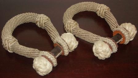 A pair of sailor-made sea-chest beckets. Dressed in rope and leather. 