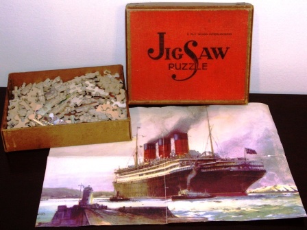 Early 20th century jig-saw puzzle in plywood (N 6910) depicting a three funnel Cunard Liner leaving harbour