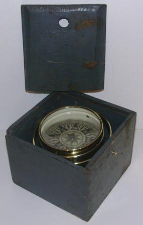 Late 19th century dry card compass made of brass. Mounted in gimbals, wooden case. 