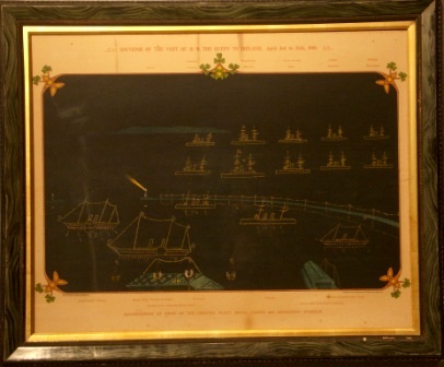 Original print commemorating H.M. the Queens visit to Ireland, April 3rd to 26th 1900. Depicting illuminations at night of the Channel Fleet, Royal yachts and Kingston Harbour. Including the Royal Yachts Osbourne and Victoria & Albert as well as the Harbour Commissioners Yacht. Also including the fleet vessels Howth, Australia, Galatea, Magnificent, Majestic, Prince George, mars, Jupiter, Hannibal, Repulse, Resolution, Melampus adn Pactolus. Further depicting Victoria Pier where the Queen landed and Carlisle Pier & Holyhead Mailboat. 