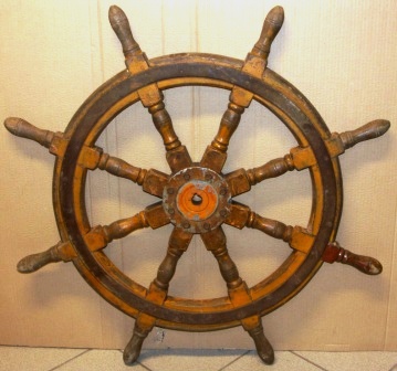 Early 20th century eight-spoked ships wheel. Oak, metal band and hub.