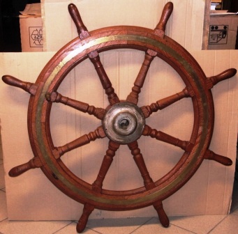 Early 20th century eight-spoked ships wheel. Stained oak, brass band and handle, metal hub.