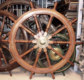 Early 20th century ten-spoked ships wheel in teak. With double brass bands and central brass hub. Made by Brown Bros. & Co Ltd Edinburgh.