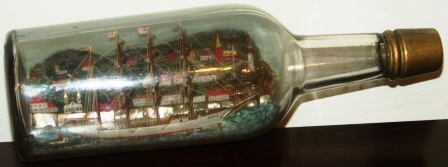 Early 20th century sailor-made ship model housed in bottle depicting the Swedish 4-masted barque VINGA and tug boat.