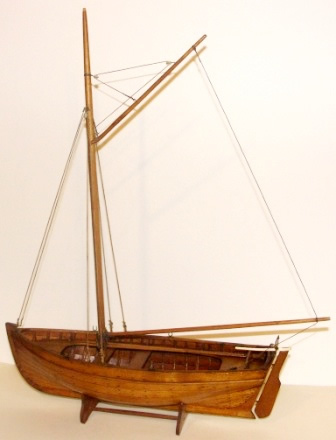 Early 20th century carvel-built, gaff-rigged and copper riveted wooden sailing boat. With tiller made of bone. 